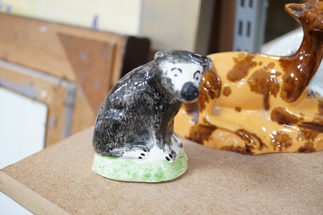 A Staffordshire Pearlware figure of a recumbent ewe, a Staffordshire glazed terracotta figure of a recumbent deer and a Staffordshire pearlware model of a badger?, largest 14cm wide